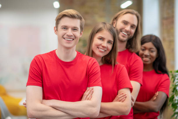 istock Young people in red tshirts looking joyful and happy 1350772187