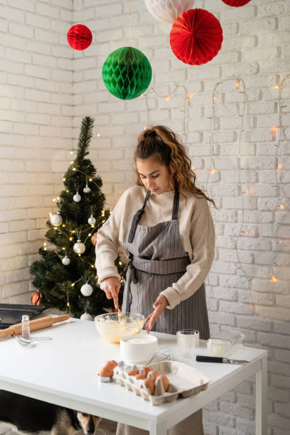istock Smiling woman in the kitchen baking christmas cookies 1350773087