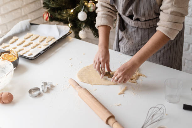 istock Smiling woman in the kitchen baking christmas cookies 1350773668