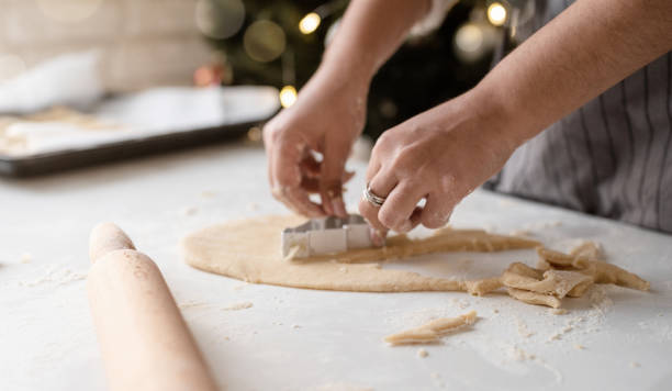 istock Smiling woman in the kitchen baking christmas cookies 1350774613