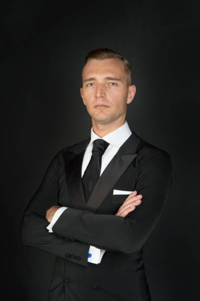 istock Man in a black tuxedo suit and white shirt 1350774876
