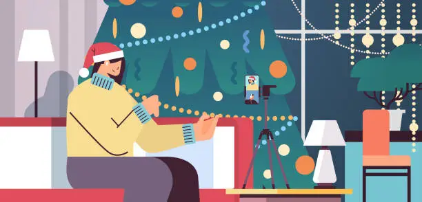 Vector illustration of woman blogger in santa hat recording video on camera girl celebrating new year christmas holidays living room interior