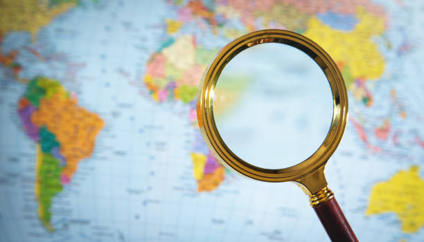 istock Magnifying glass over the world map. 1350780393