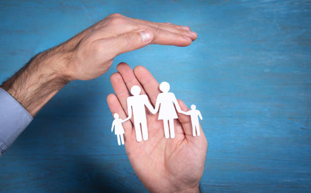 istock Human hands showing paper cut family. 1350780417