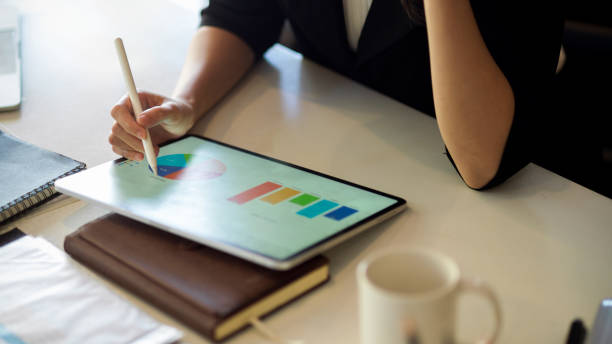 istock Cropped close-up female executive using stylus pen and digital tablet 1350784210