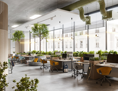 3D rendering of an environmentally friendly office. Three-dimensional image of office space with work desks and light coming from large windows.