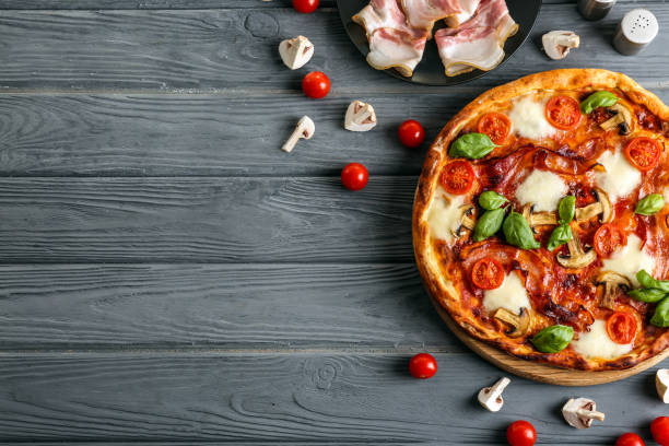 istock Flat lay composition with pizza and ingredients on wooden background 1350787143