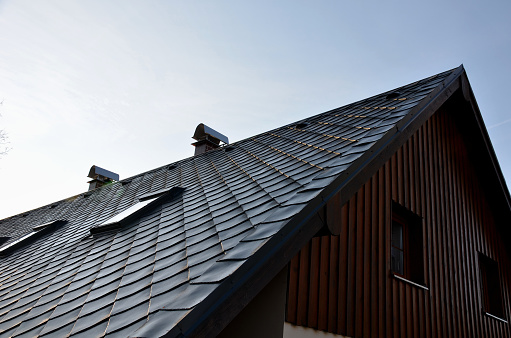 gray roof tiles with windows square slate template. square grid pattern. the lower edge of the roof is formed by a metal strip for framing  better tearing off  layer of snow heat transfer through  , window