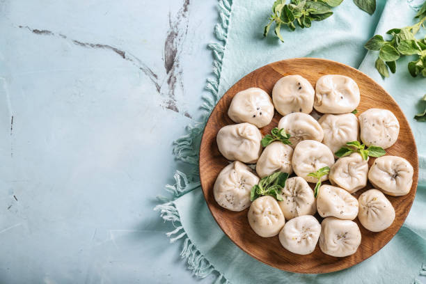Plate with tasty Chinese dumplings on table stock photo