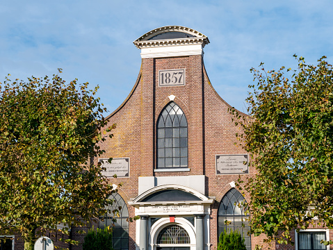 Top of front facade of Baptist Church in city of IJlst, Friesland, Netherlands