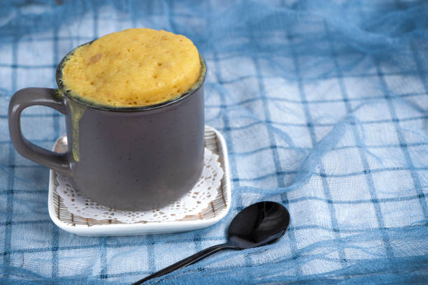 istock vanilla mugcake is microwaved. Homemade cupcake in a coffee mug. 1350789647