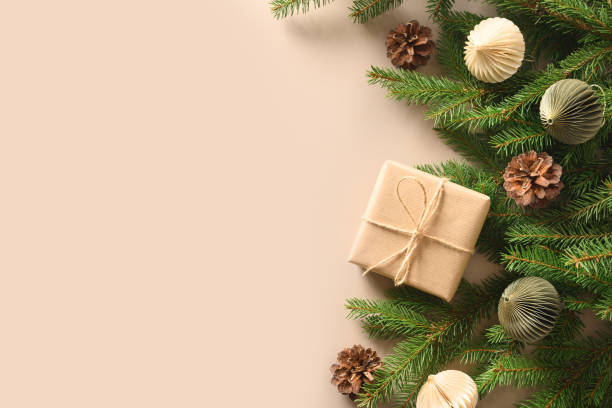 istock Christmas craft eco gift and festive composition with pine cones on beige background. 1350790615