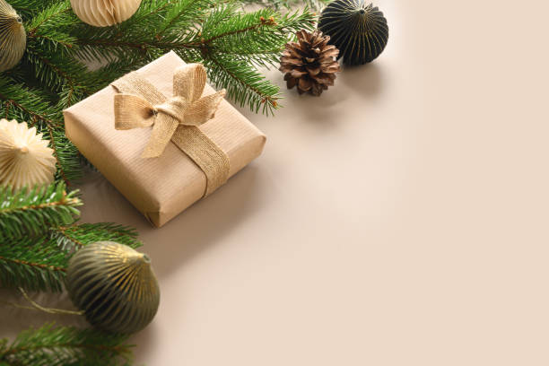 istock Christmas craft eco gift and festive composition with pine cones on beige background. 1350790619