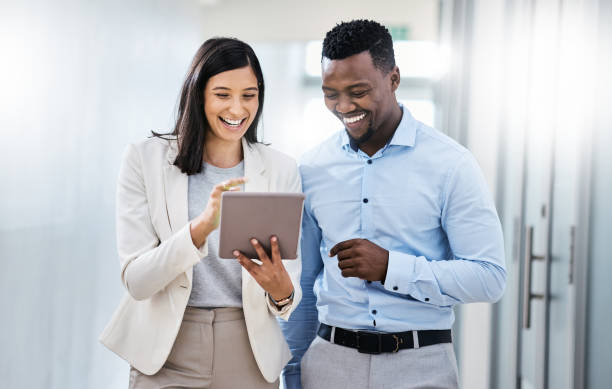 istock Shot of two businesspeople discussing something on a digital tablet 1350790871