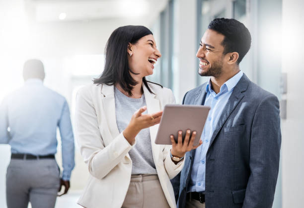 istock Shot of two businesspeople discussing something on a digital tablet 1350790875