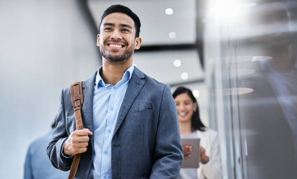 Shot of a business smiling while walking through the office