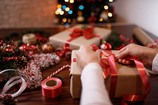 istock Woman wrapping Christmas presents 1350793173