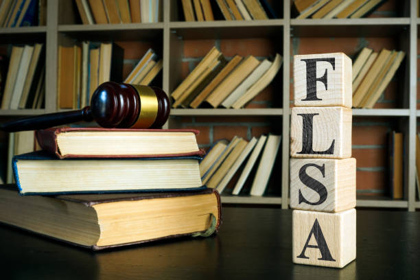 istock Books, gavel and cubes with FLSA or Fair Labor Standards Act. 1350793707