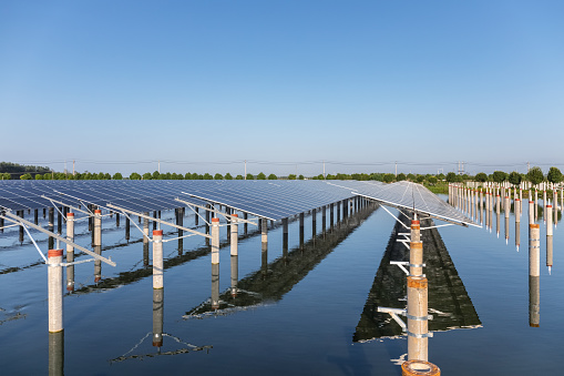 neat solar panels and concrete pillar in water
