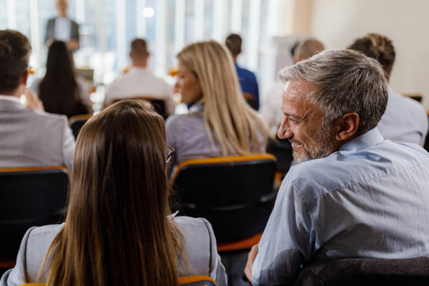 istock Business colleagues talking on education event in board room. 1350794950