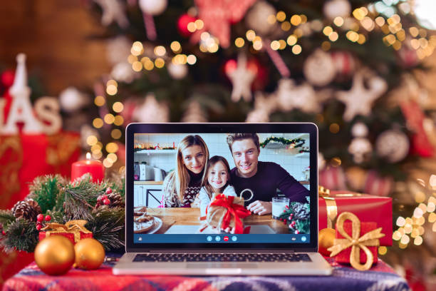 istock Family video call on laptop computer screen on Christmas table background. 1350795166