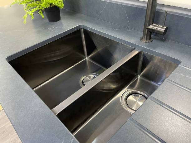 istock Image of modern, rectangular, stainless steel kitchen sink with 1.5 bowl sink and integrated draining board, stainless steel, single lever monobloc mixer tap, focus on foreground 1350795262
