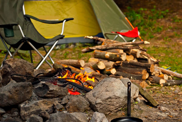 istock Empty armchairs for relaxing on a campfire background. Beach chairs around the fire. Night vacation in nature. 1350795994