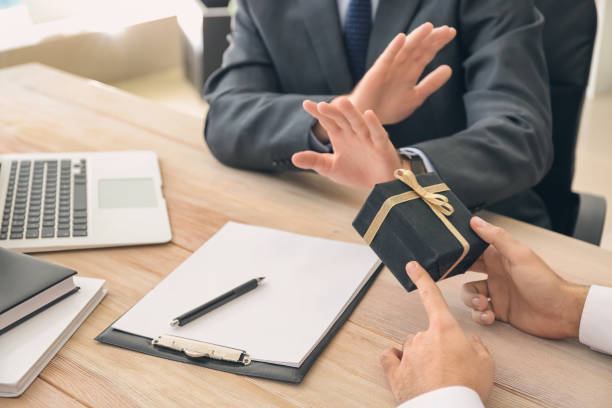 Businessman refusing to take bribe in office. Concept of corruption stock photo