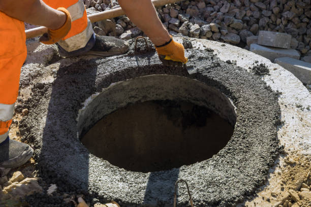 istock A worker the new road construction work on preparation for installation of sewer hatches 1350797201