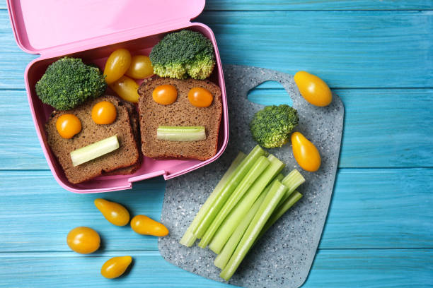 istock Lunch box with tasty creative food for kid on table 1350797897
