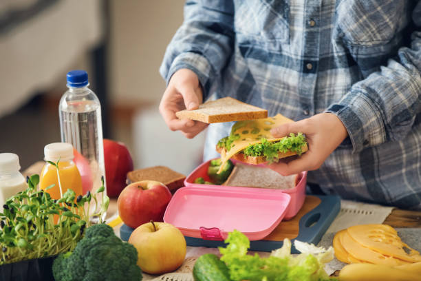 istock Mother preparing lunch for schoolchild at table 1350797898