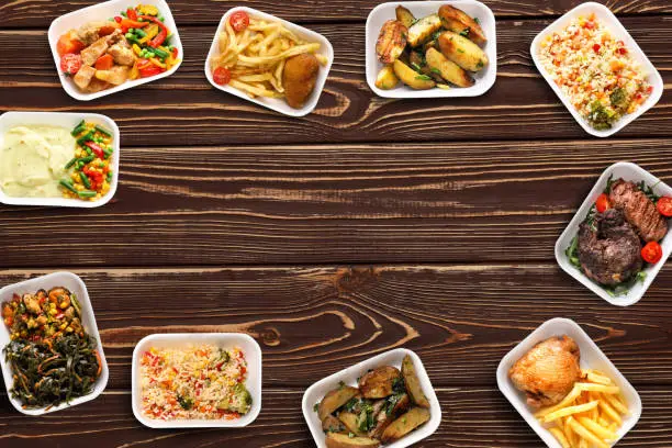 Photo of Plastic containers with delicious food on wooden table. Delivery service