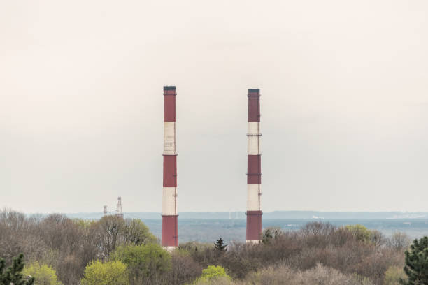 istock Two chimneys on sky background. Industry air pollution concept. 1350799336