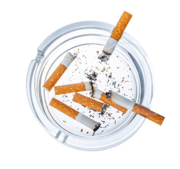 istock Burnt cigarette butts in an ash tray isolated on white 1350799929