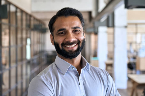 Happy indian business man leader manager standing in office, headshot portrait. Happy smiling bearded indian business man small business owner, company leader or sales manager, male hispanic ceo executive, successful lawyer looking at camera standing in office, headshot portrait. insta stock pictures, royalty-free photos & images