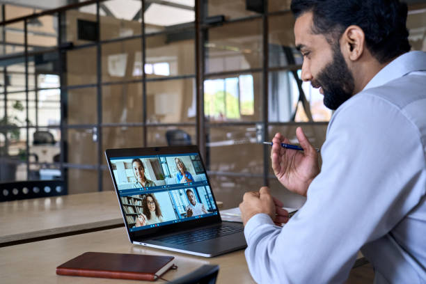 istock Indian smiling executive ceo businessman having working video call in office. 1350801502