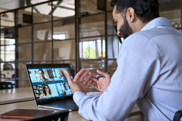 istock Indian smiling executive ceo businessman having working video call in office. 1350801560