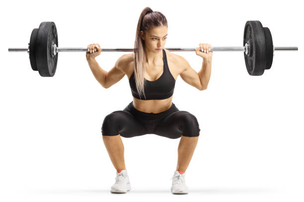 Fit young woman bodybuilder kneeling with heavy weights Fit young woman bodybuilder kneeling with heavy weights isolated on white background woman weight training stock pictures, royalty-free photos & images