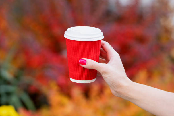 istock hand hold paper coffee cup on colorful background, morning 1350804287