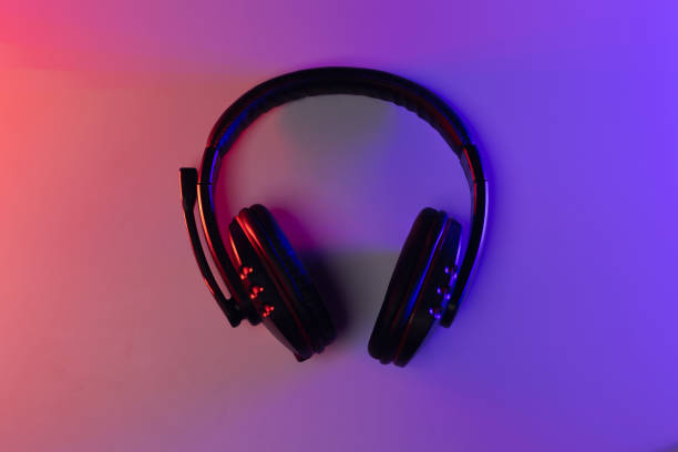 istock Accessory gaming keyboard joystick mouse headphone with blank space. Gadget for gamer playing video game online in the neon light darkroom. 1350804394