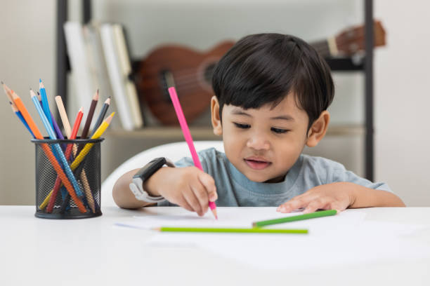istock Asian little boy education from home. Developing children's learning before entering kindergarten Practice the skills of drawing and painting. 1350804514