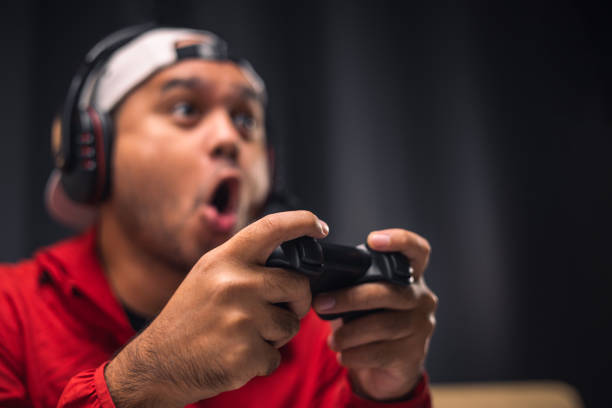 istock Close up male hands holding joystick game console. Young man playing video game online. 1350804637