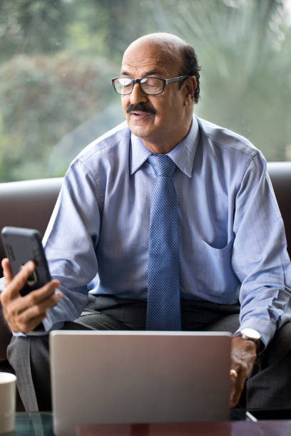 istock Businessman using laptop at mobile phone at office 1350804652