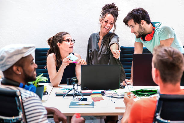 istock Millenial friends employees group workers on computer at startup studio - Human resource business and teamwork concept by laptop working time - Start up entrepreneurs at office - Bright vivid filter 1350807170