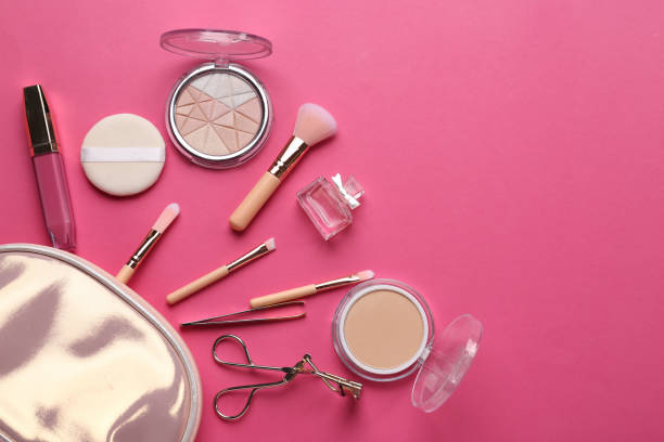 istock Bag with professional makeup cosmetics and brushes on color background 1350813052
