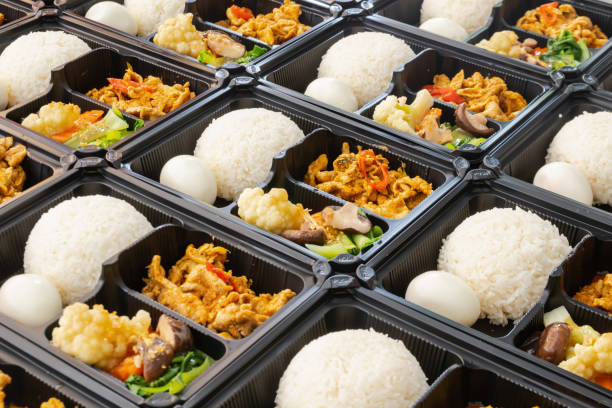istock Thai food lunch boxes in plastic packages. Rice with Thai red pork curry. 1350813347