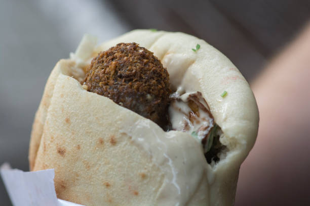 Close up view of a Pita bread with Falafel, a typical middle eastern food, deep fried balls made of ground chickpeas, usually served with Tahini sauce. Tel Aviv, Israel