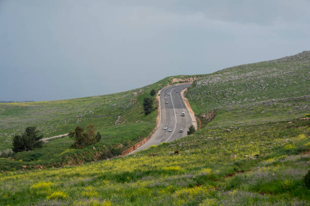 Cars passing in a four lanes road, in the green mountains of Sefad, Israel stock photo
