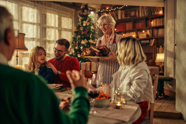 istock Happy extended family having New Year's lunch at dining table. 1350815403