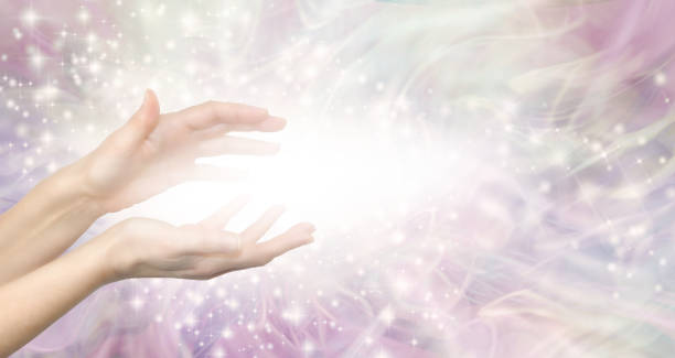 Healing Energy Lightworker Healing Hands and white light message banner female hands with white light between against a pale pink ethereal shimmering background with copy space reiki stock pictures, royalty-free photos & images